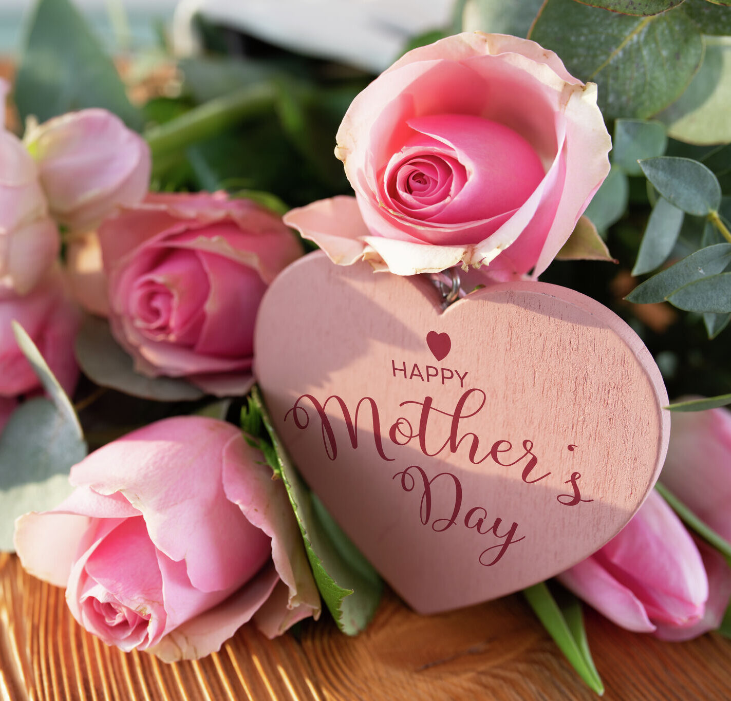 Image of pink roses and a mothers day gift tag saying happy mothers day which is challenging when you are faced with infertility